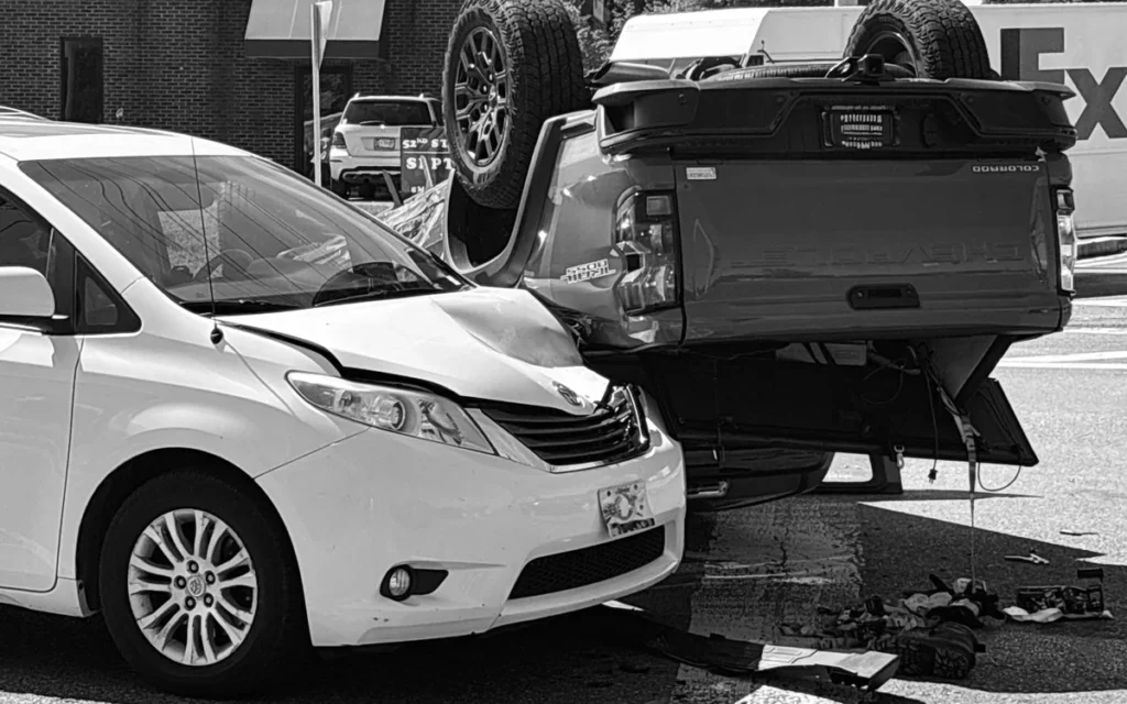 White Toyota minivan with pickup truck bed resting on windshield
