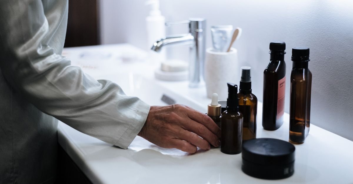 Small skincare tray with cleanser and moisturizer on a bathroom counter at sunrise