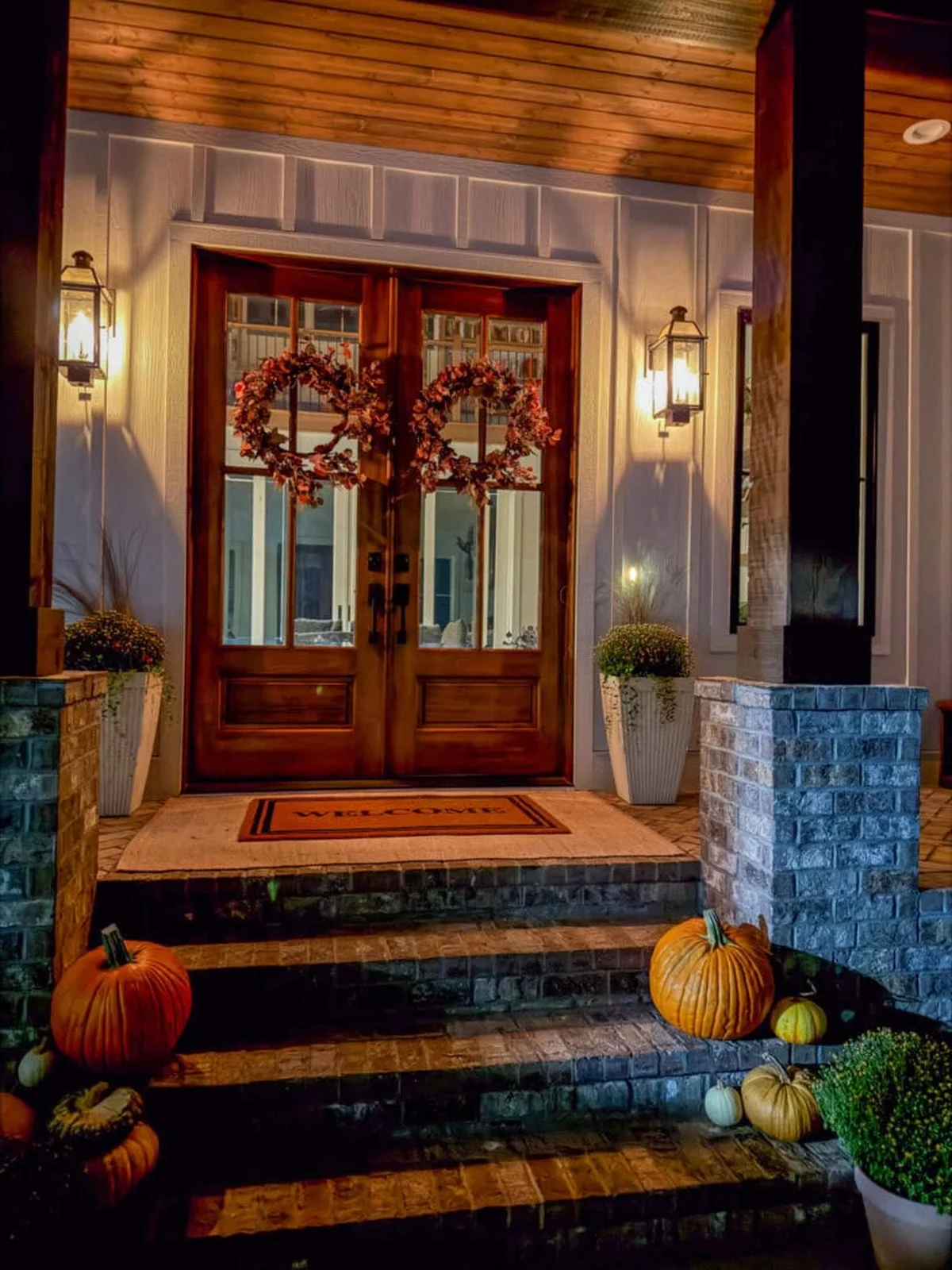 autumn decorated front porch with wreaths and pumpkins
